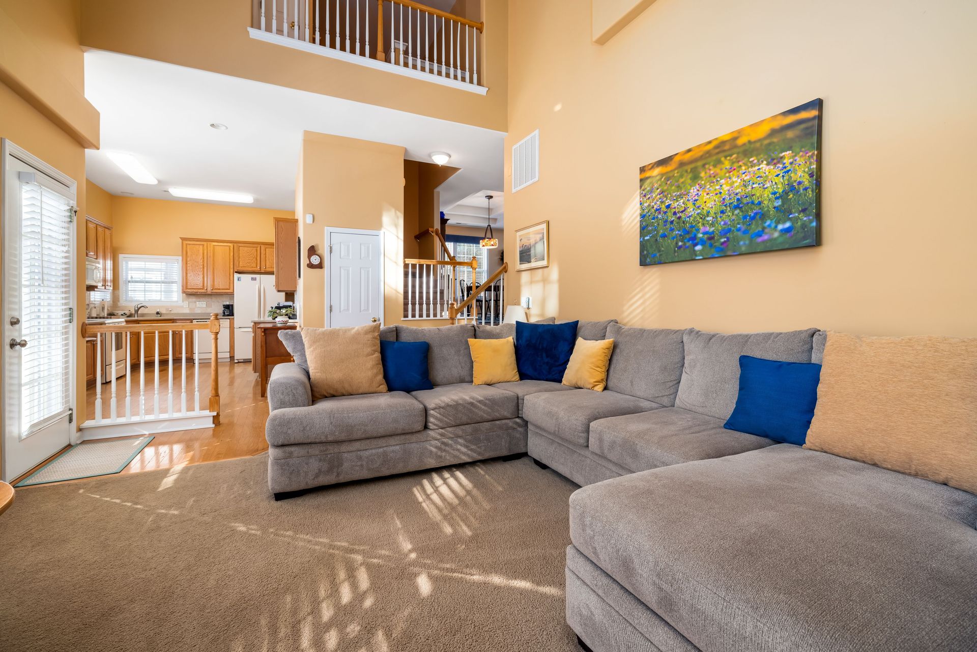 Bright and spacious living room showcasing a cozy grey sofa and modern interior design.